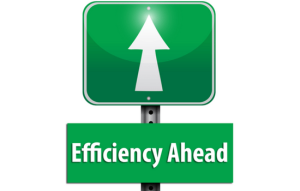 A green road sign that points forward with white arrow and says 