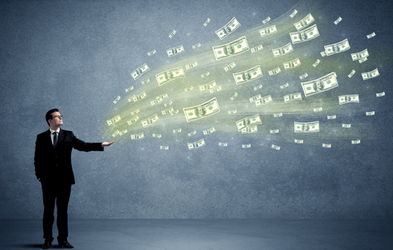 A man in a suit standing in front of a blue background throwing $100 bills into the air.