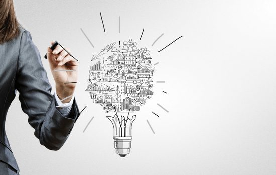A light bulb vector art with a woman drawing more ideas and thoughts out of it.