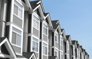 grey townhomes with white trim in a multifamily complex