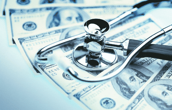 money under stethoscope with blue filter