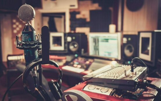 Broadcast studio with a radio microphone sitting in the middle of the room.