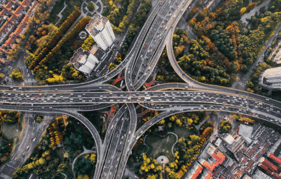 An aerial image of a major highway with a lot of traffic going in all directions.