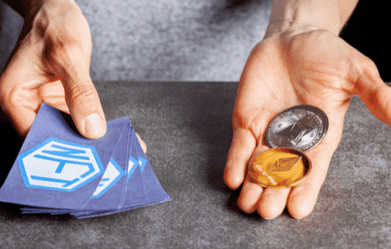 NFT tokens and bitcoins in the palm of an individual's hands.