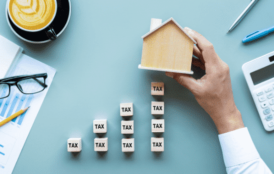 Multiple wood blocks with the words TAX on each of them.