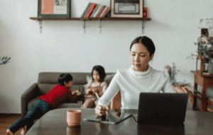 Employee in a remote work environment with two kids in the background.