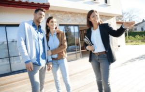 Real estate agent touring a prospective couple a property.