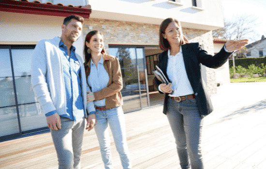 Real estate agent touring a prospective couple a property.