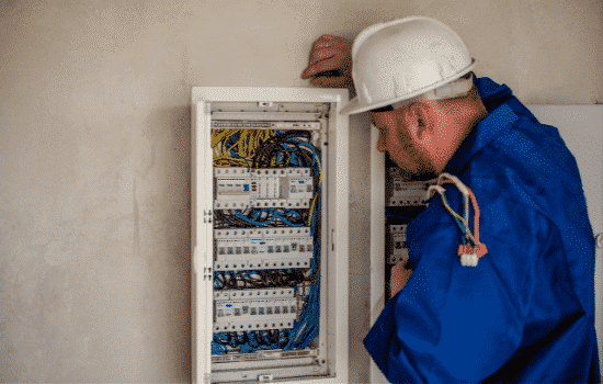 Electrician working on a service box.