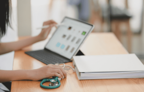 A nurse inputting information on a tablet.