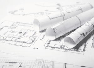 Construction blueprints sitting on a table.