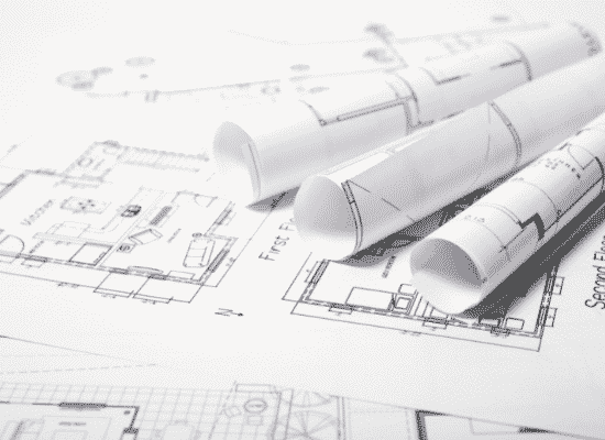 Construction blueprints sitting on a table.