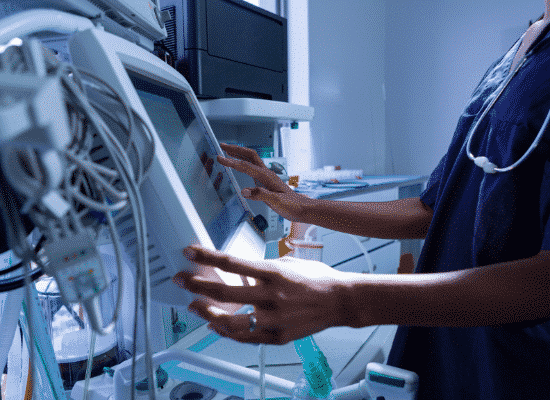 A nurse looking at a heart monitor