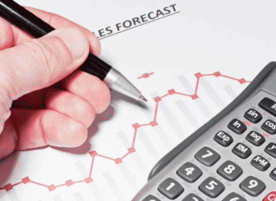 An accountant working on a forecasting worksheet.
