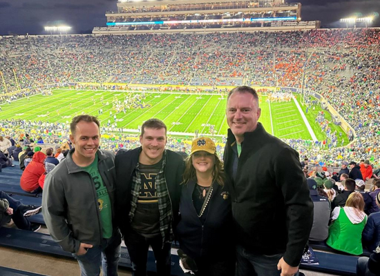 Photo of the James Moore Collegiate Athletics team at a college football game.