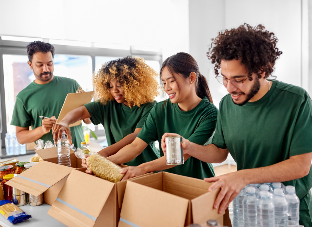 Nonprofit volunteers are packing boxes with food donations.