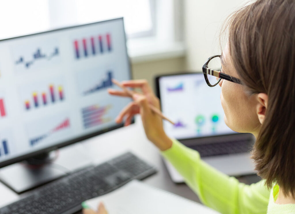NCAA and EADA Reporting Advisor financial business analytics woman with data dashboard graphs