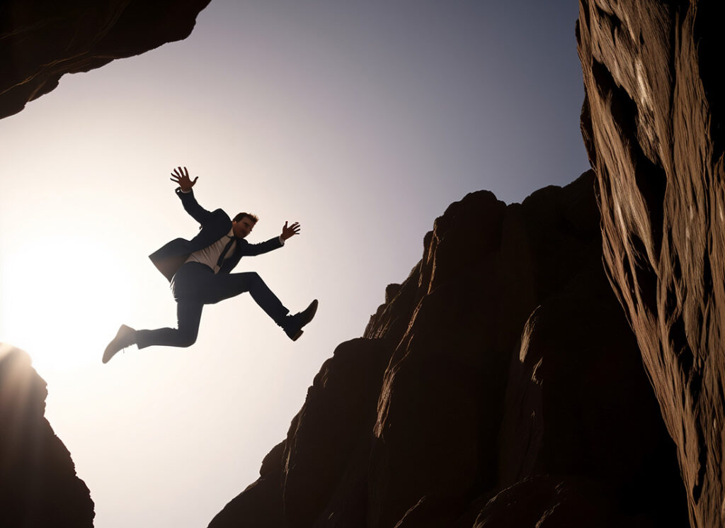 businessman jumping between two boulders outdoors ,