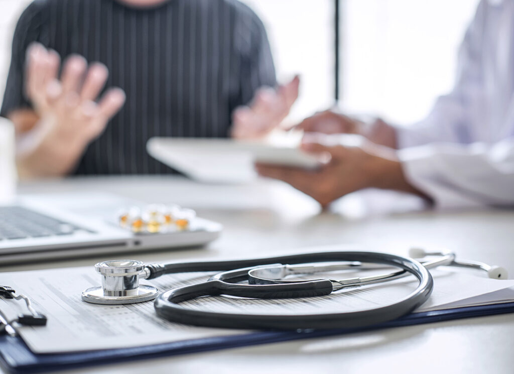 Proper HR Training in Healthcare – What You Don’t Know Can Hurt You. Doctor consulting patient discussing something symptom of disease and recommend treatment methods, presenting results on report and prescription, Medicine and health care concept.