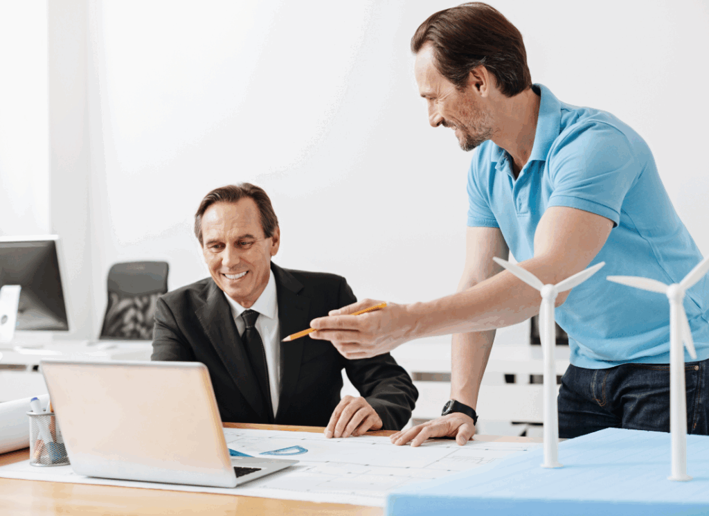 A construction worker and company owner are at a desk discussing the benefits of an employee stock option plan (ESOP).