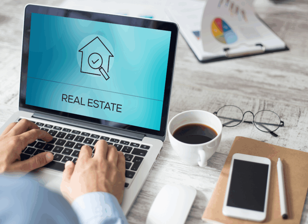 Person working on a laptop displaying a real estate screen, symbolizing the financial tech for real estate.