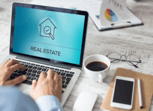 Person working on a laptop displaying a real estate screen, symbolizing the financial tech for real estate.