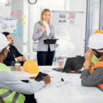 A manager leads a collaborative WIP meeting at a construction company.