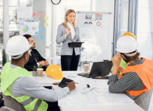 A manager leads a collaborative WIP meeting at a construction company.
