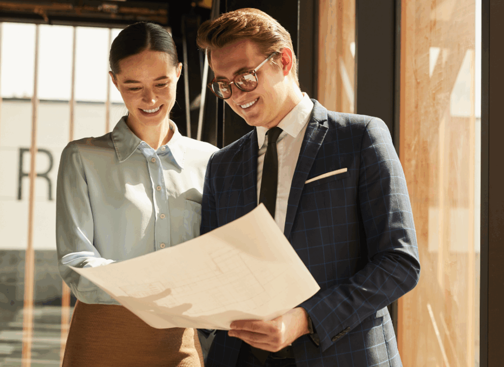 A real estate CPA and property manager review building plans together, symbolizing the added value of a CPA working alongside the property manager.