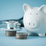 A piggy bank, stethoscope, and stacked coins symbolizing healthcare funding and practice acquisition financing.