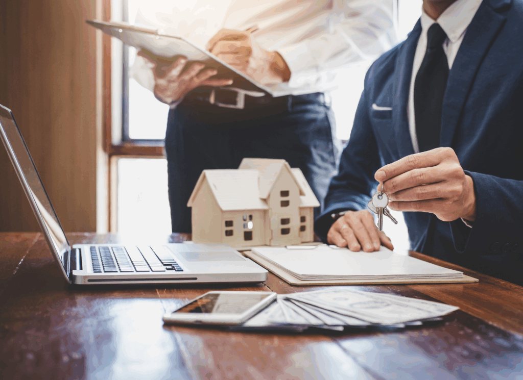 A real estate developer reviews documents while holding keys, illustrating Top Financial KPIs for Developers in property investment decisions.