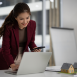 Real estate professionals reviewing Yardi accounting software and financial reports during business meeting