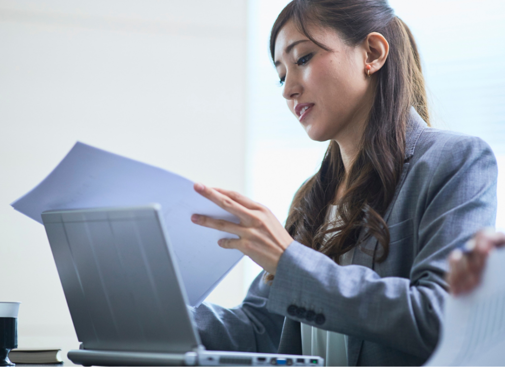 Real estate investor reviewing property-level and portfolio accounting reports on laptop computer
