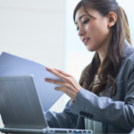Real estate investor reviewing property-level and portfolio accounting reports on laptop computer