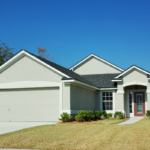 Grey house in Florida on a sunny day with large lawn