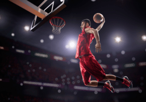 Alston awards NCAA reporting featured image basketball player making a slam dunk