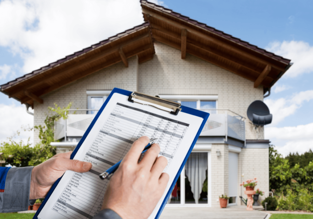 Energy Efficient Tax Incentives featured image A person is standing outside of a home holding a clip board and pen. The clip board and the person's hands are visible in front of the house.