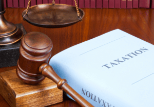Farhy v. Commissioner featured image A gavel and balance are on a desk in a law office next to a book with the title "Taxation" written on the front.