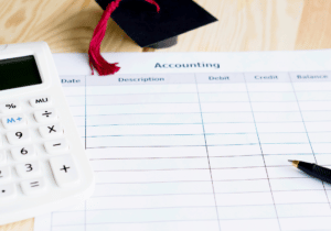 GASB 96 SBITAs featured image 1100 x 800 A calculator, pen, and small graduation cap are on top of piece of paper that appears to be a financial statement.