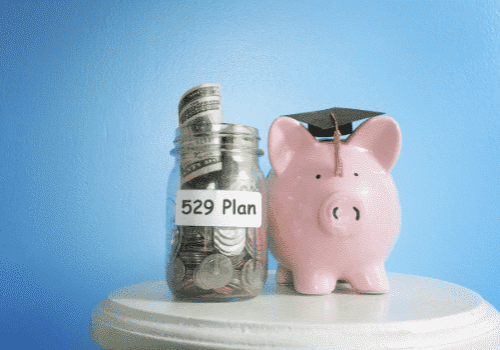overfunded 529 jar with money and piggy bank with mortar board overfunded 529 jar with money and piggy bank with mortar board