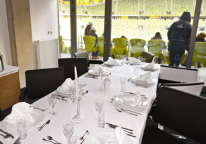 luxury skybox at stadium, dining table in foreground